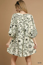 NEWYORKLISTED STYLE COLLECTION: Woman wearing a patterned dress on a beige background