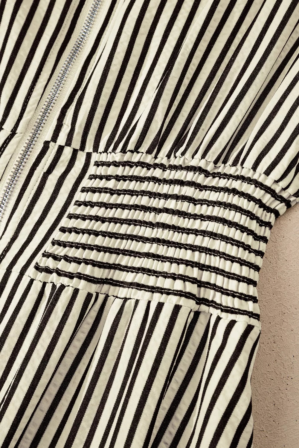 NEWYORKLISTED STYLE COLLECTION: Close-up of a black and white striped garment with a textured pattern.