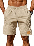 NEWYORKLISTED ATLAS MEN'S COLLECTION: Beige shorts with a drawstring on a plain background