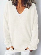 NEWYORKLISTED STYLE COLLECTION V-Neck Dropped Shoulder Sweater in soft knit white fabric on a minimalist white background