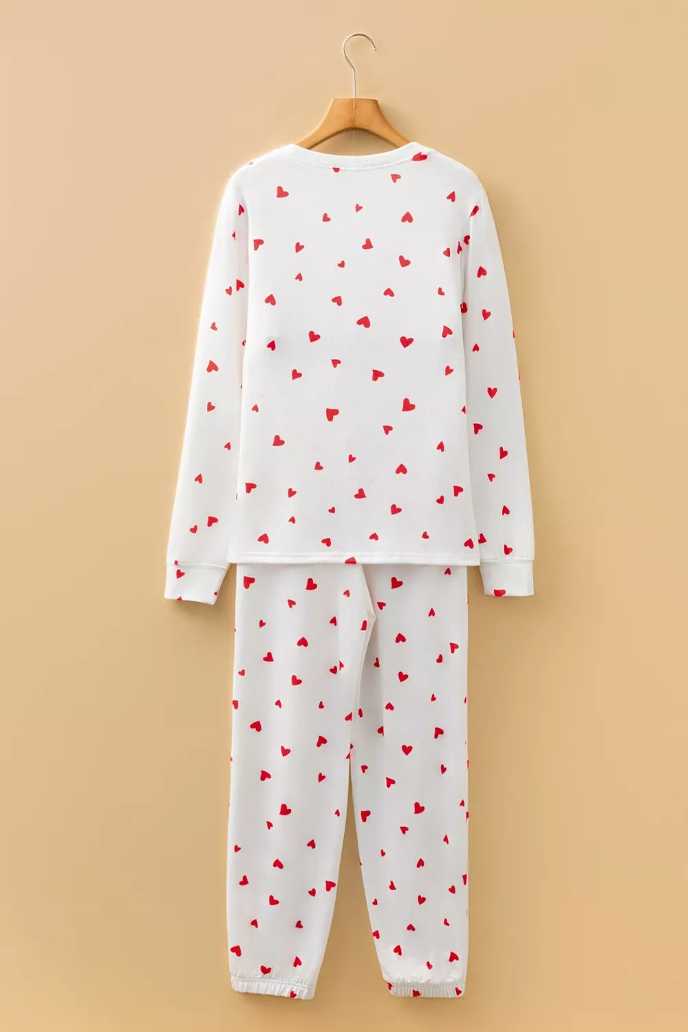 NEWYORKLISTED Intimate Apparel Collection: pajama set with red heart patterns on a beige background