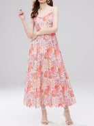NEWYORKLISTED STYLE COLLECTION: Woman wearing a floral dress on a gray background