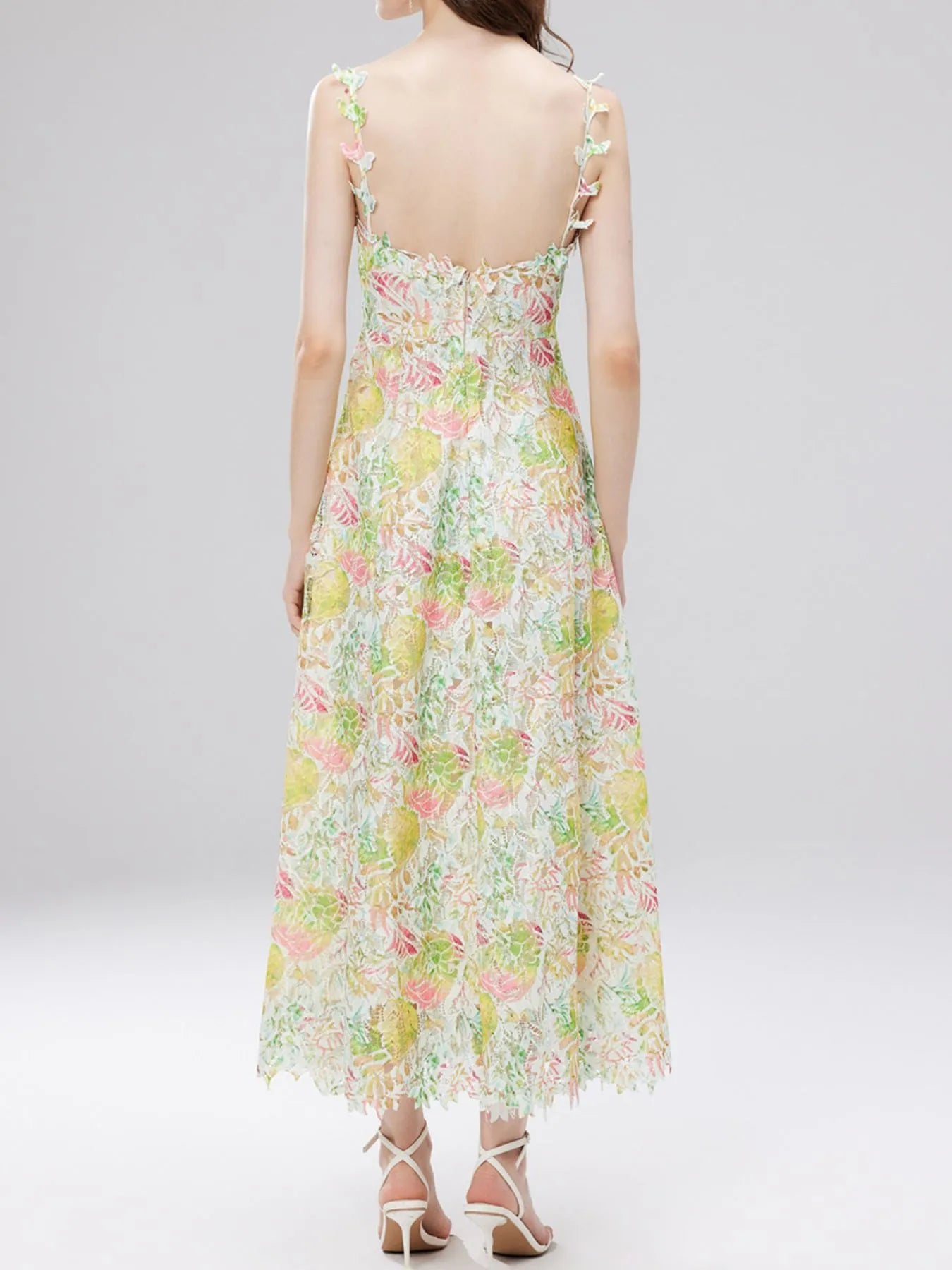 NEWYORKLISTED STYLE COLLECTION: Woman wearing a floral dress on a plain background