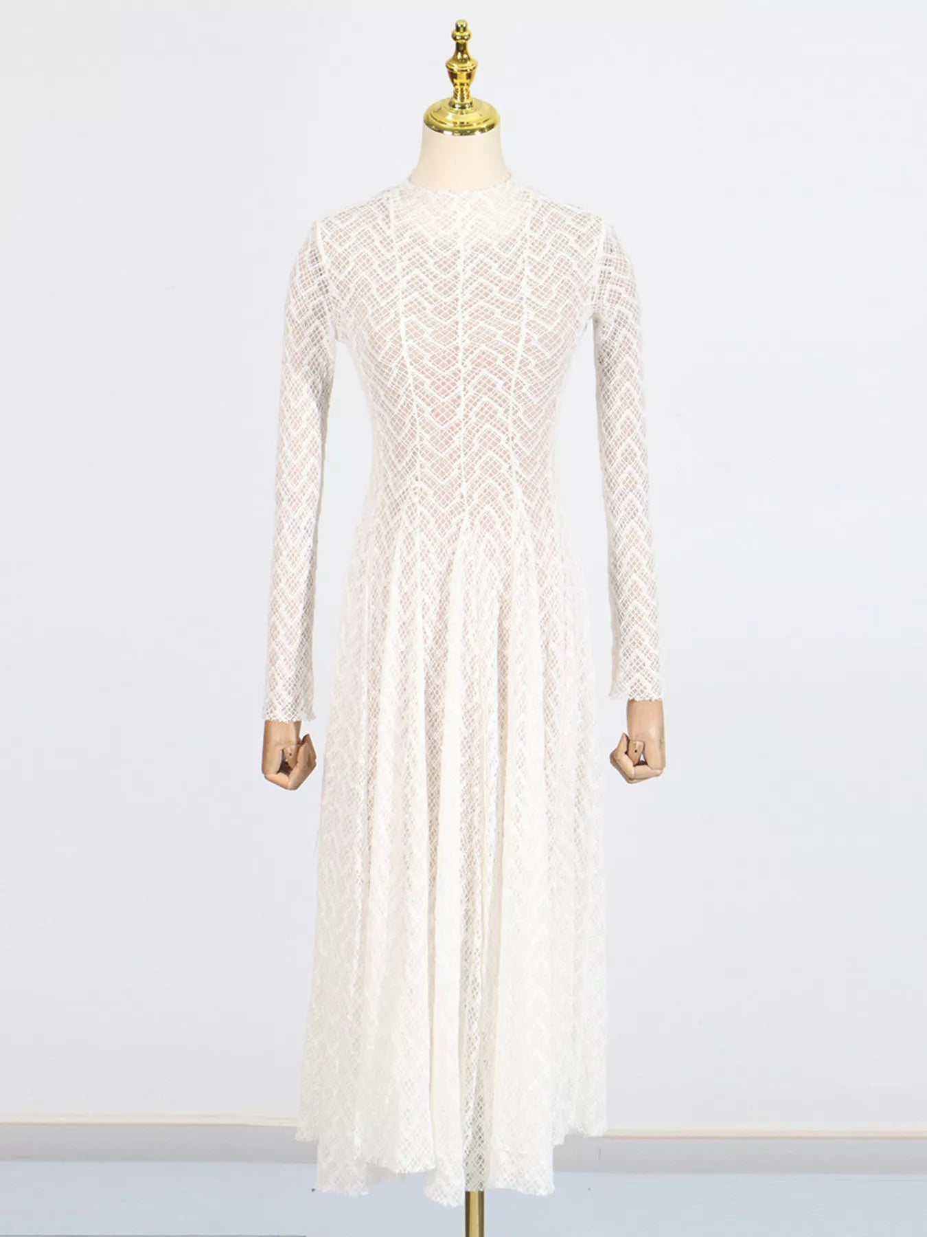 NEWYORKLISTED STYLE COLLECTION: White lace dress on a mannequin against a white background