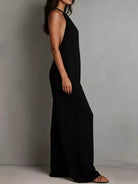 NEWYORKLISTED STYLE COLLECTION: Person wearing a black halter neck dress against a plain background