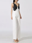 NEWYORKLISTED: White jumpsuit with black geometric top on a white background