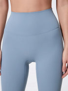 Light blue leggings worn by a person on a plain background