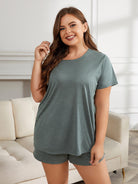 NEWYORKLISTED Intimate Apparel Collection: Woman wearing a green t-shirt and shorts set in a living room.