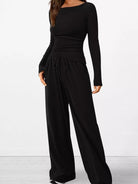 Black long-sleeve jumpsuit on a white background
