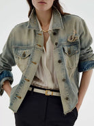 NEWYORKLISTED STYLE COLLECTION: Person wearing a light blue denim jacket over a white shirt with a plain background