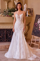 NEWYORKLISTED ELEGANT BRIDE COLLECTION: Woman in a white lace wedding dress standing in an elegant room with decorative elements.